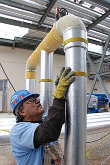 Fitting insulation to pipes, Pueblo County Pueblo Chemical Agent-Destruction Pilot Plant Agent Processing Building (6554017433).jpg