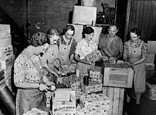 Australian Red Cross workers pack boxes for Christmas 1942, including Contack games Red Cross workers packing Christmas presents for the Fighting Forces during World War II, 1942 (4189609872).jpg