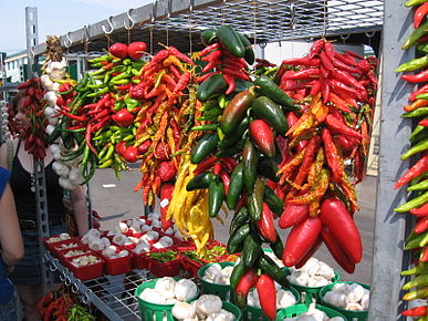 Ristras of jalapeños, other chili peppers, and garlic at a market in Montreal.