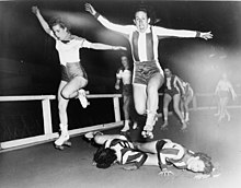 Two women's league roller derby skaters leap over two who have fallen in a 1950 bout in New York City. Roller Derby 1950.jpg