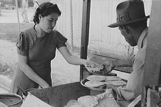 "Preparing plates of tortillas and fried beans to sell to pecan shellers, San Antonio, Texas" by Russell Lee, March 1939