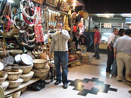 Market stall selling trutrucas and kultrunes along with other Mapuche craft items (individual is playing a trutruca)