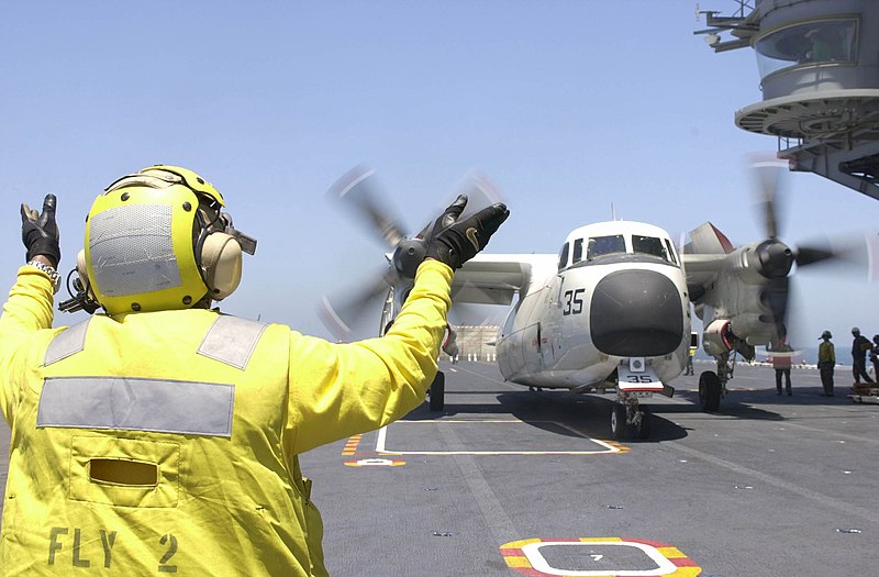 File:US Navy 020806-N-1974E-001 C-2 Greyhound receives instructions from flight deck director.jpg