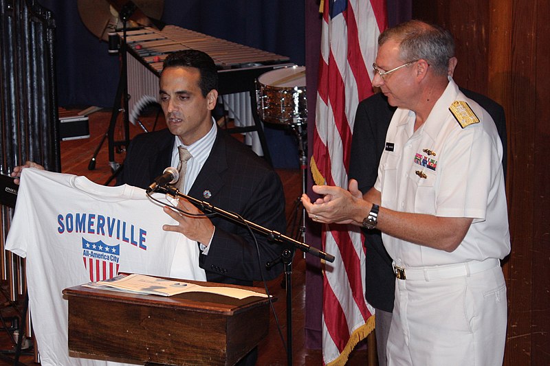 File:US Navy 090702-N-8110K-098 Mayor Joseph Curtatone presents his city's t-shirt to Vice Adm. Kevin M. McCoy, Commander, Naval Sea Systems Command prior to a performance by the U.S. Navy Band Northeast at Somerville High School.jpg