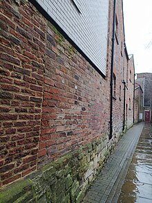 Walls on Black Horse Passage, at the rear of Fossgate, showing stonework believed to be part of the friary wall York Camelite Friary wall.jpg