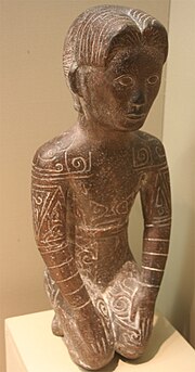 A Yue ("barbarian") statue of a tattooed man with short hair from the para-Austronesian cultures of southern China, from the Zhejiang Provincial Museum Yue statue.jpg
