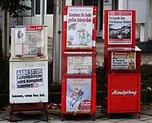 In Munich, Germany, the dispensers for the three local tabloids (depicted) have only transparent plastic lids on top which can be readily opened without inserting a coin - which is, however, demanded. Hence, the sellers have a significant amount of trust in people. Zeitungsautomaten in Muenchen.JPG