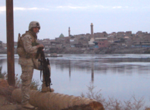 A U.S. Marine Infantryman (0311) with 1/2 Bravo Company patrols alongside the Euphrates River in Hit, Iraq, 2005. 0311hit.PNG