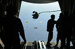 Soldiers from the 1st Commando Company parachute with their inflatable boats from an RAAF C-130H into Shoalwater Bay