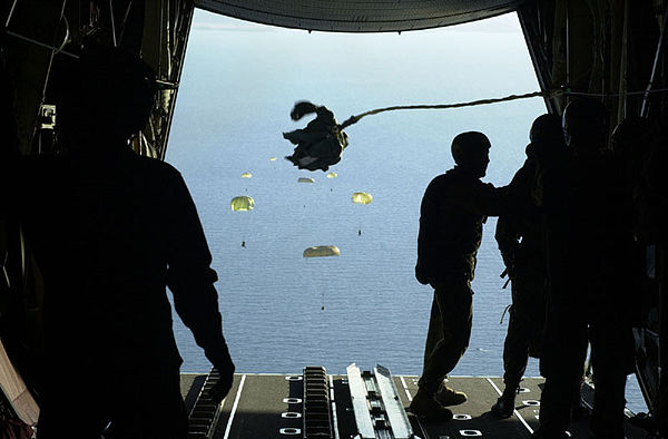 Soldiers from the 1st Commando Company parachute with their inflatable boats from an RAAF C-130H into Shoalwater Bay