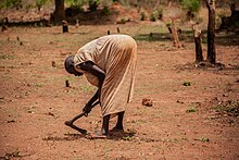 A Murle woman trying to clear land for Agriculture A woman clearing land for farming in South Sudan.jpg