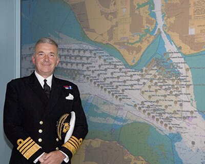 Admiral Sir Alan West, then First Sea Lord, is pictured with the official chart of anchorages for the International Fleet Review