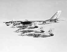 Three VF-143 F-14As intercept a Tu-95 in 1982 An air-to-air left side view of three Fighter Squadron 143 (VF-143) F-14A Tomcat aircraft as they intercept and escort a Soviet Bear reconnaissance aircraft. The Soviet aircraft was - DPLA - 458d39bb89951c35094ecf427595ffed.jpeg