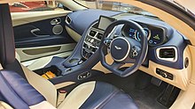 Interior of a luxury coupe, showing a mix of black and beige