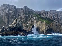 Ocean waves crashing against sea cliffs at Cape Pillar, Tasmania in Australia. Cape Pillar Sea Cliffs.jpg