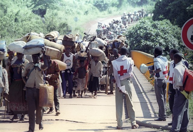 Red Cross volunteers monitoring and assisting displaced populations during the Rwandan Civil War, 1994.