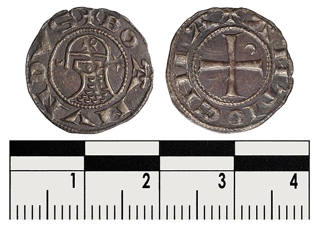 A rather unusual coin in the name of Bohemond. A bust sits in profile wearing a round helmet emblazoned with a cross with a prominent nasal-guard and 