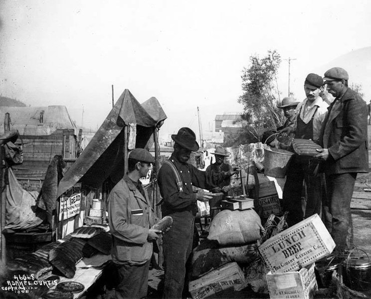 File:Disappointed gold seekers selling their outfits along the Dawson waterfront, Yukon Territory (CURTIS 560).jpeg