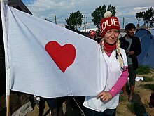 Alison Thompson holding her heart flag. Dr. Alison Thompson heart flag.jpg