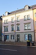 Apartment building in closed development and corner location and outbuildings