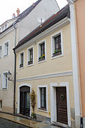 Residential house in closed development, with shop with original front from around 1850