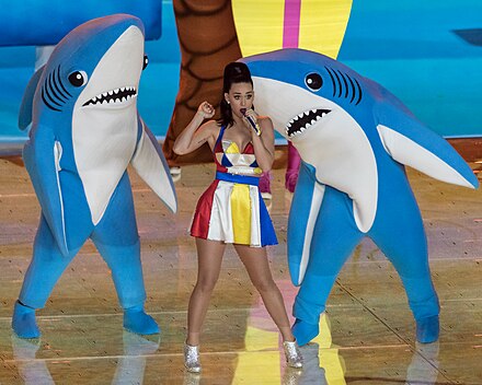 Perry with backup dancers in shark costumes during the performance of "Teenage Dream"