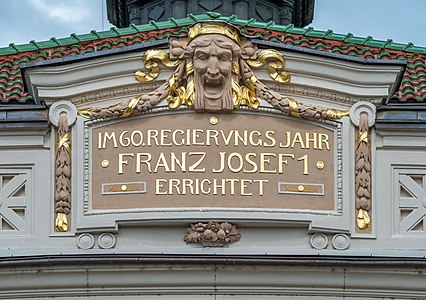 Inscription with mascaron at the Stadttheater, Klagenfurt, Austria