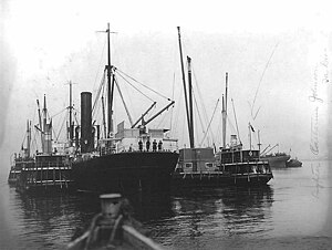 The freight lighters Metcalf No. 1 (left), George H. Johnson (center right), and Catherine Johnson (right) tied up alongside a British cargo ship (center left) on 5 May 1917. Lighters Metcalf No. 1, George H. Johnson, and Catherine Johnson alongside Britiish freighter.jpg