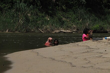 Batek people bathing in the Tembeling River, Pahang, Malaysia.