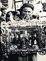 A man holding a beautiful frame filled with various medals issued by the Nguyễn Dynasty and the French.