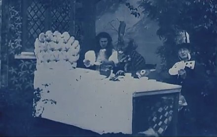 May Clark as Alice (left) and Norman Whitten (right) as the Mad Hatter in Alice in Wonderland (1903), the first film version of the story