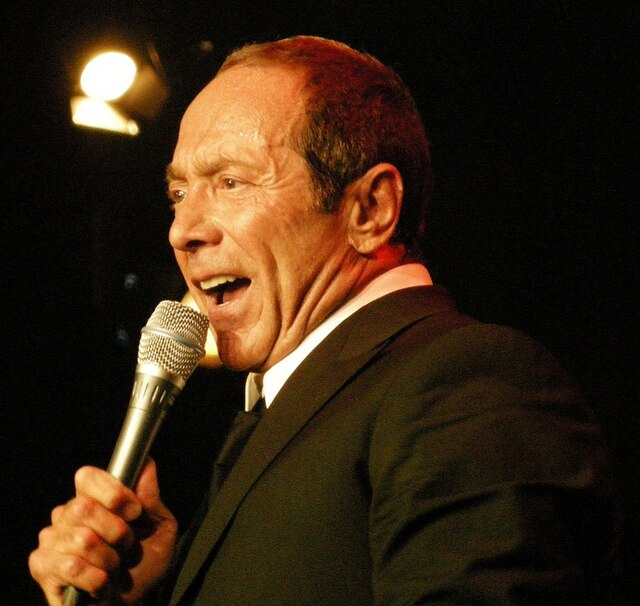 A man is singing while holding a microphone