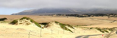 The western terminus of Route 166 snakes through the Guadalupe-Nipomo Dunes, which end at the Pacific Ocean Route 166 end Guadalupe-Nipomo Dunes.jpg