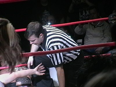 Dan Engler refereeing for TNA