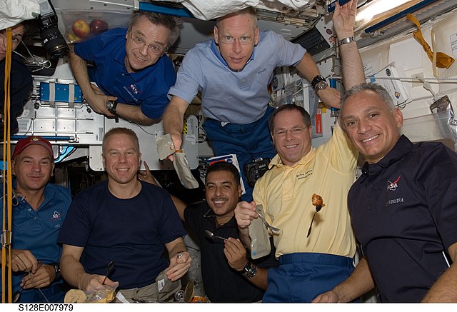 Hernández (center, bottom) inside Node 1 of the ISS during STS-128