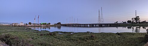 Panorama at the mouth of Seal Slough (2022); road bridges are in the background and construction cranes on the left are being used during the reconstruction of the city wastewater treatment plant. Seal Slough.jpg