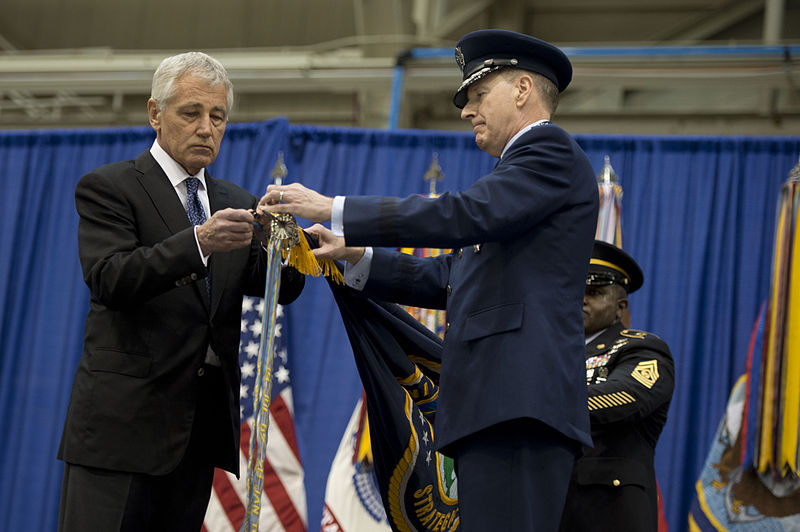 File:Secretary of Defense Chuck Hagel, left, and U.S. Air Force Gen. C. Robert Kehler place a Joint Meritorious Unit Award streamer on the U.S. Strategic Command (USSTRATCOM) colors during a change of command 131115-D-BW835-338.jpg