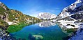 A panoramic view of the Seebensee. In the centre, the Wetterstein mountains are reflected in the surface of the lake