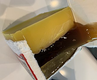 Elements that result from melting beehive wax - from bottom: slumgum, honey, beeswax Slumgum.jpg