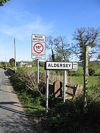 Stile and Road Signs at Coddington - geograph.org.uk - 414551.jpg