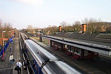 Relief line platforms; the River Thames is to the left of and below the blue railings on the left. Tilehurst railway station 1.JPG