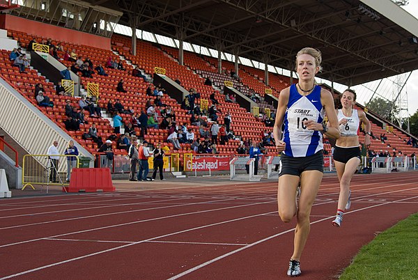 Young athletes run past the Tyne and Wear stand at Gateshead International Stadium