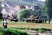 Civilians watching a formation of American M60 tanks during Reforger 82 U.S. Army during REFORGER '82.JPEG