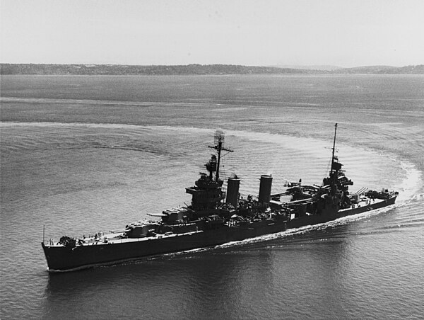 USS New Orleans (CA-32), steams through a tight turn in Elliott Bay, Washington, on 30 July 1943, following battle damage repairs and overhaul at the 