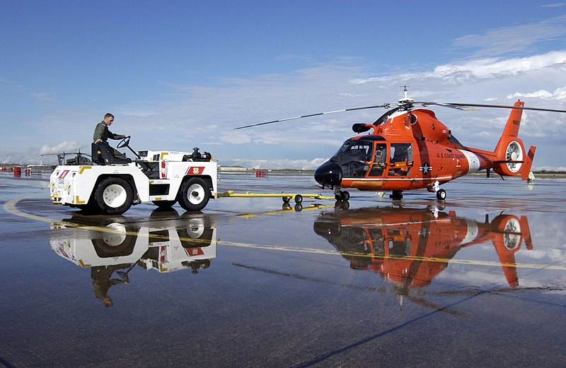 File:US Navy 050307-C-0379W-012 A member of Coast Guard Air Station Houston, Texas, maneuvers an HH-65B Dolphin rescue helicopter in position after a hard rain.jpg