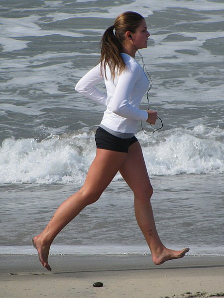 File:Woman running barefoot on beach.jpg