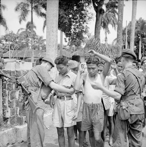 Men of the 12th Battalion, Parachute Regiment search suspects in Batavia during the operation to take control of all civil administration buildings in