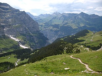 The Wengernalp, to the right, looking down into the Lauterbrunnen valley. Wengernalp station can be seen in the distance to the right hand side; the resort of Murren is on the far side of the valley. 5197 - Near Eigergletscher Station.JPG