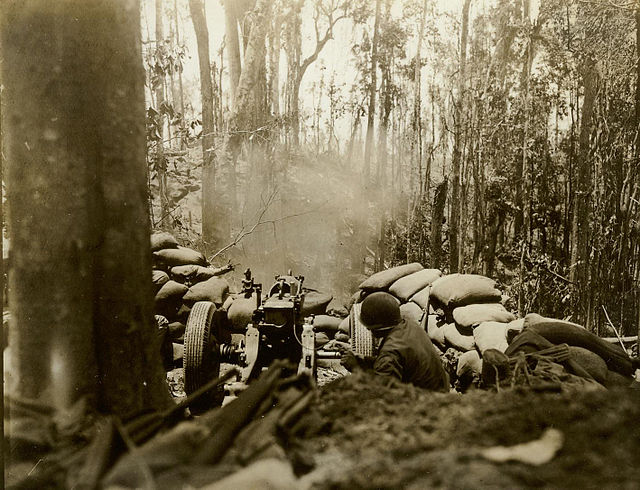 A U.S. Army 75 mm pack howitzer firing at close range at a Japanese position on Hill 260 in March 1944