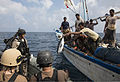 A Yemeni fisherman aboard a dhow gives a fish to U.S. Sailors assigned to the guided missile destroyer USS Mason (DDG 87) during a visit, board, search and seizure operation Nov. 21, 2013, in the Gulf of Aden 131121-N-PW661-023.jpg